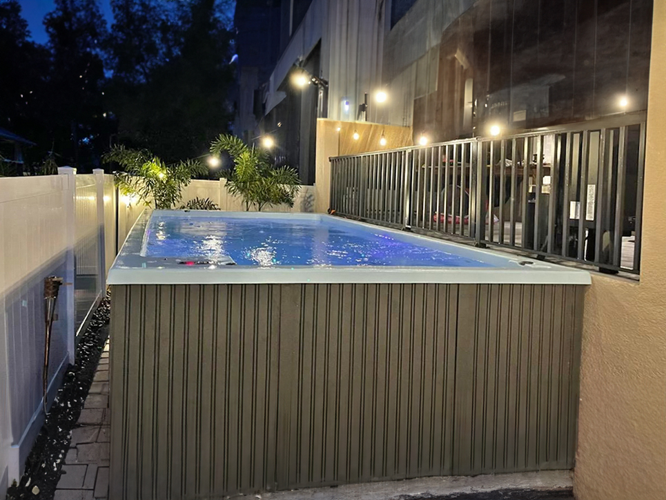 Buffalo pools and spas to show Swim Spa inside custom fenced privacy area.